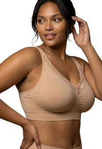 Woman wearing a beige wirefree bra against a white background